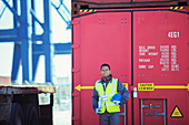 Worker smiling near cargo container