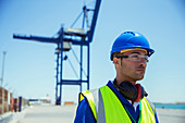 Worker standing near cargo crane