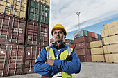 Worker standing near cargo containers