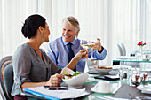 Smiling mature couple raising toast