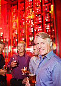 Mature man holding beer glass