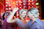 Mature couple dancing in night club