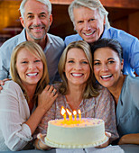 Mature men and women with birthday cake