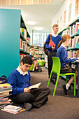 Teenage students in college library