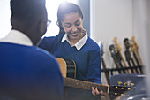 Students playing acoustic guitar