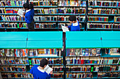 Students browsing books in library