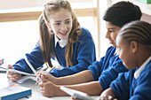 Pupils using tablet pc's in classroom