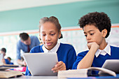Pupils using tablet pc's in classroom