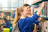 Students choosing books in library