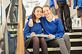 Female students sitting on steps