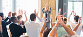 Smiling man standing before audience