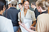 Smiling women holding files