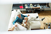 High angle view of older couple on sofa