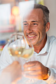 Smiling older man toasting