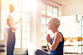 Older woman meditating on floor