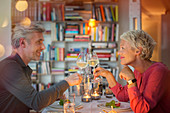 Older couple toasting each other