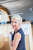 Businesswoman holding paperwork in office