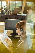 Businesswoman wearing headset and working