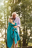Grandfather drying grandson with towel