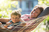 Father and son relaxing in hammock