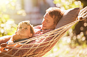 Father and son relaxing in hammock