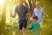Boy, father and grandfather walking