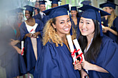 Students with diplomas standing