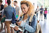 Female student standing and texting