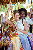 Young multiracial couple on carousel