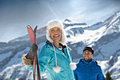 Couple with skis at mountain