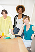 Smiling office workers talking at desk