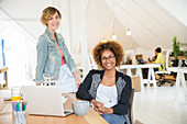 Women smiling with laptop on desk