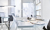 Messy table of modern office with laptop