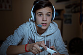 Boy with headset playing video game