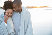 Portrait of couple wrapped in blanket