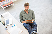 Man sitting with legs in studio