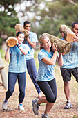 Determined people running with logs