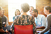 People laughing in group therapy session