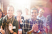 Portrait of smiling audience clapping