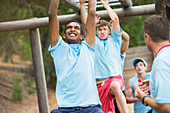 Determined men swinging on monkey bars