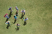 People spinning in plastic hoops