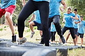 Determined people jumping tires