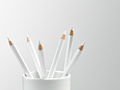 White pencils in white cup still life