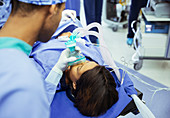 Anaesthesiologist holding oxygen mask