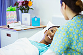 Smiling patient bed smiling at nurse