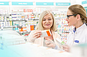 Pharmacist and customer reading label