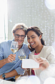 Couple with white wine taking selfie
