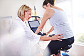 Physical therapist guiding woman