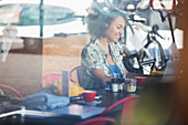Smiling woman with headphones in cafe