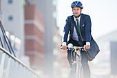 Businessman riding bicycle in city